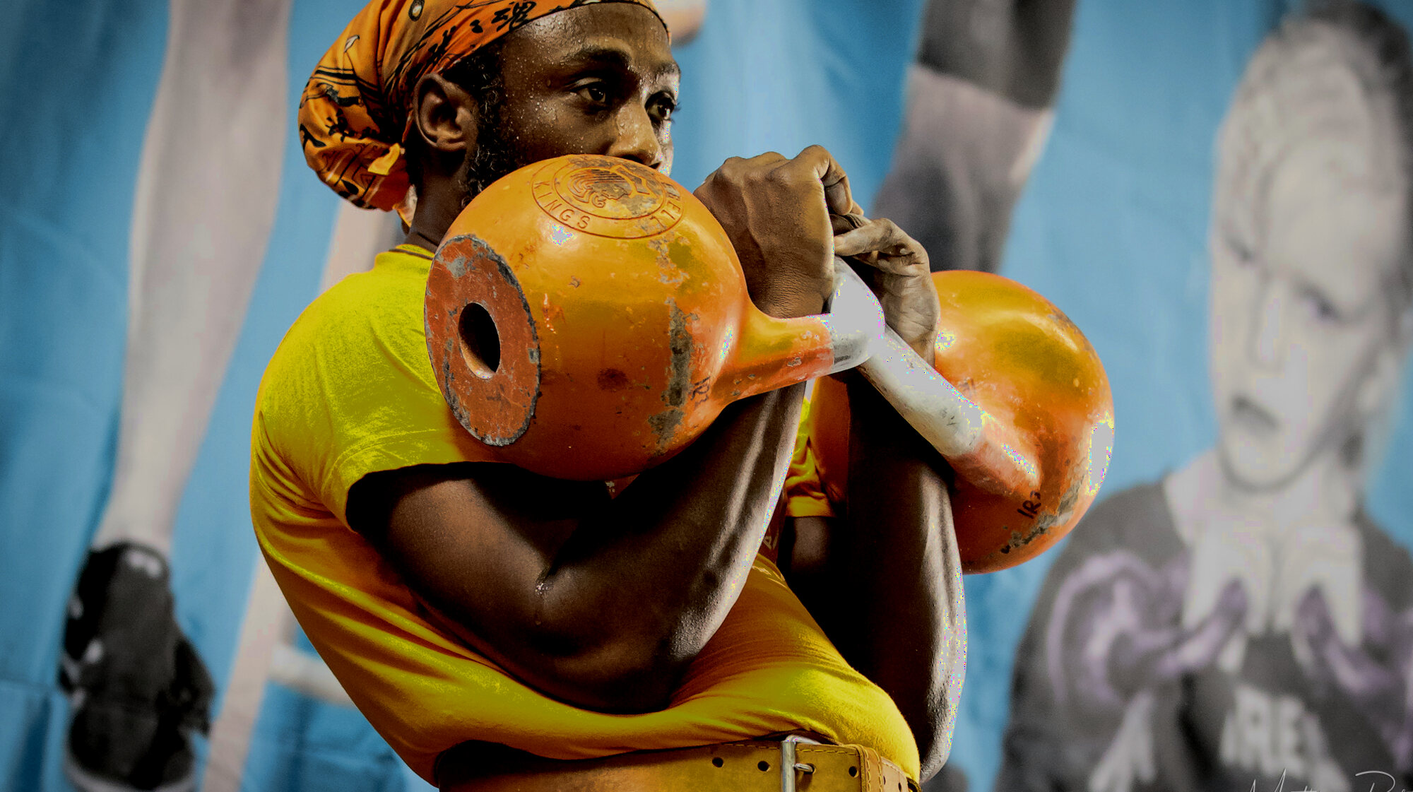 Irvin Charleston holding two competition kettlebells in the rack position