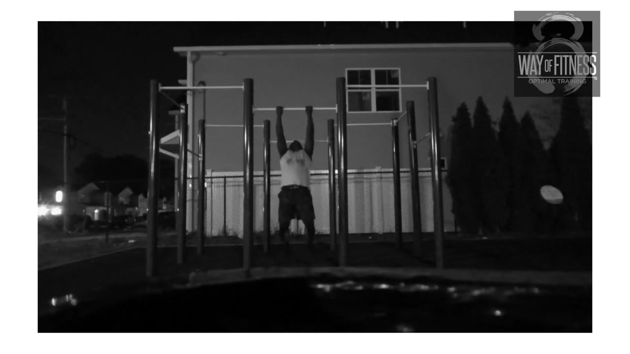 Irvin Charleston doing a push-up at an outdoor calisthenics park at night